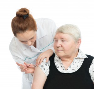 Doctor making senior woman patient an arm subcutaneous insulin