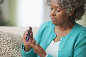 African woman using diabetes test kit
